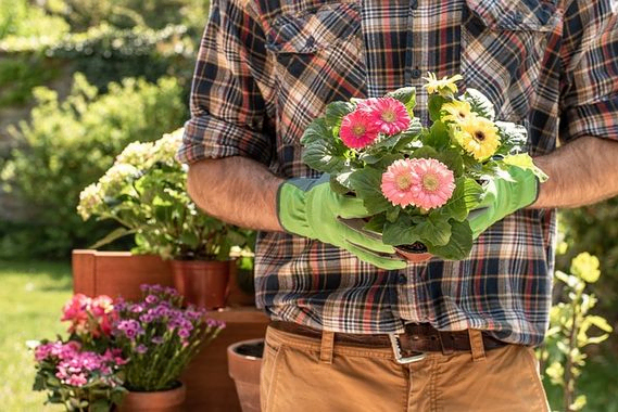 Jardinero con flores en la mano
